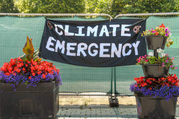 "Climate Emergency" banner on a metal fence in Cardiff Cardiff, Wales - July 2019: "Climate Emergency" banner hung on a metal fence in Cardiff city centre as part of the climate change event by Extinction Rebellion. No people. climate crisis photos stock pictures, royalty-free photos & images