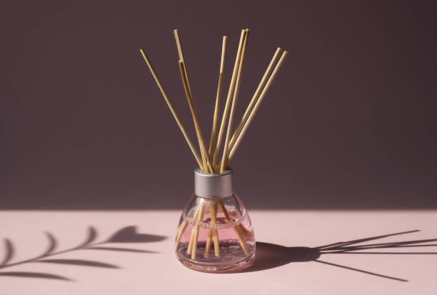 aromatic reed air freshener on pink background hard shadow. aromatherapy sticks. - air freshener imagens e fotografias de stock