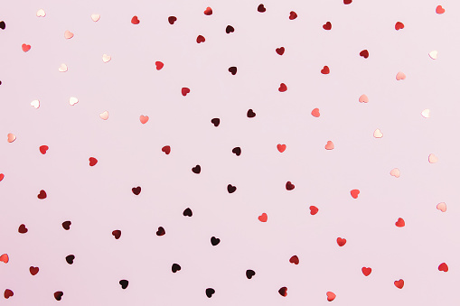 Red heart glitters on the pink background. High quality photo