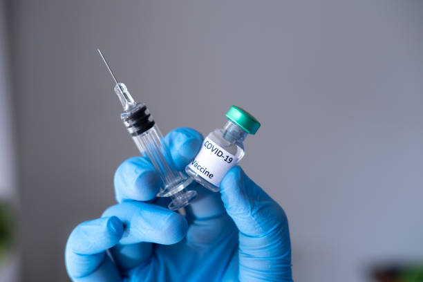 istock Syringe, medical injection in hand. Vaccination equipment. 1294488855