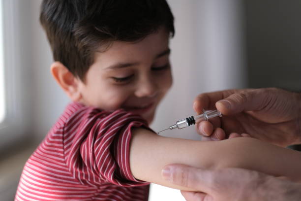 Doctor giving child patient injection Doctor giving child patient injection measles stock pictures, royalty-free photos & images