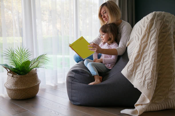 istock Mother reading a book to her little daughter 1294489740