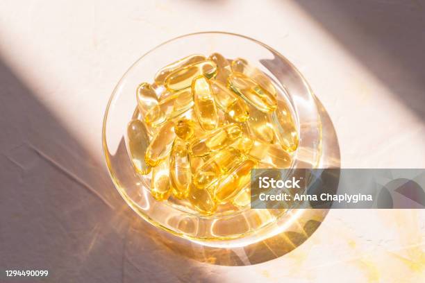 Cod Liver Fish Oil Capsules In Glass Bowl On Pink Stock Photo - Download Image Now - Omega-3, Capsule - Medicine, Macrophotography