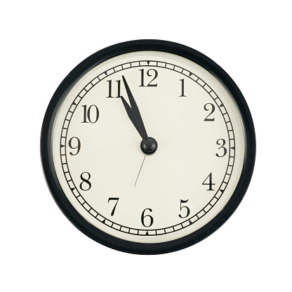 Classical round wall clock with white face isolated on a white background.