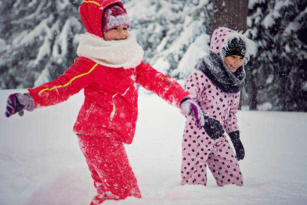 istock Two girls are playing in the snow 1294491165