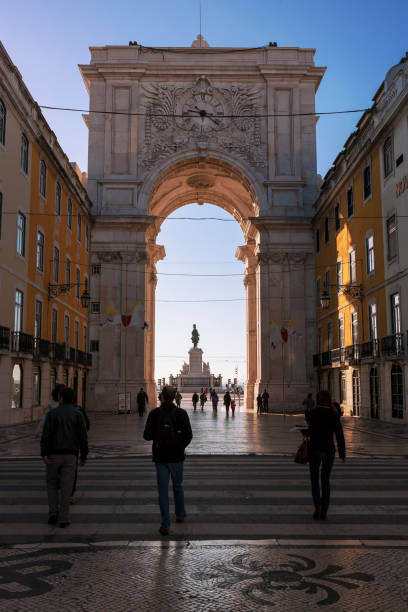 Rua Augusta and the Arco Triunfal, Baixa, Lisbon, Portugal Rua Augusta, Baixa, Lisbon, Portugal: 9th February 2018.  The Arco Triunfal da Rua Augusta and, through the arch, the Praça do Comércio and the Statue of King José I.  This downtown area, the Pombaline Baixa, is an elegant district, rebuilt to strict plans after the 1755 earthquake which destroyed much of central Lisbon.  It is an important tourist destination. baixa stock pictures, royalty-free photos & images