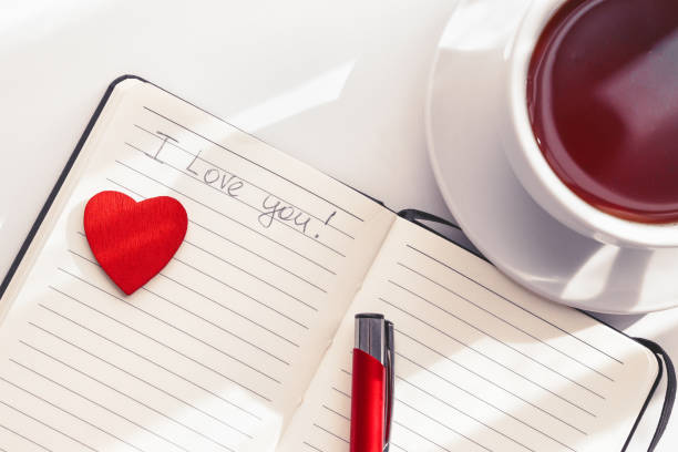 istock Cup of tea and notebook with heart and message 1294492107