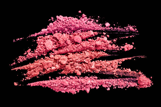 istock Bright coral purple pink smudged make-up gradient texture palette concealer foundation matte blusher powder on pink and black isolated background 1294492179