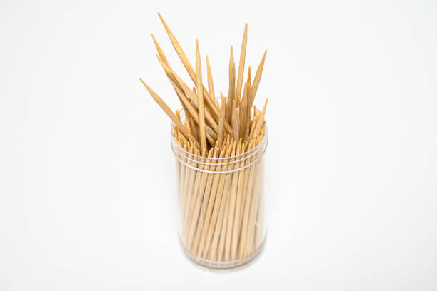 Wooden toothpicks sticking out plastic jar isolated white background Wooden toothpicks sticking out plastic jar isolated white background. High quality photo toothpick stock pictures, royalty-free photos & images