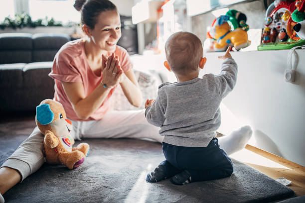 istock Mother playing with baby son on the floor 1294494188