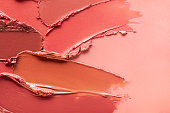 Smudged vibrant red purple scarlet pink claret maroon textured tint or lipstick on white isolated background