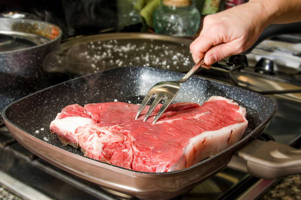Steak in cooking stock photo