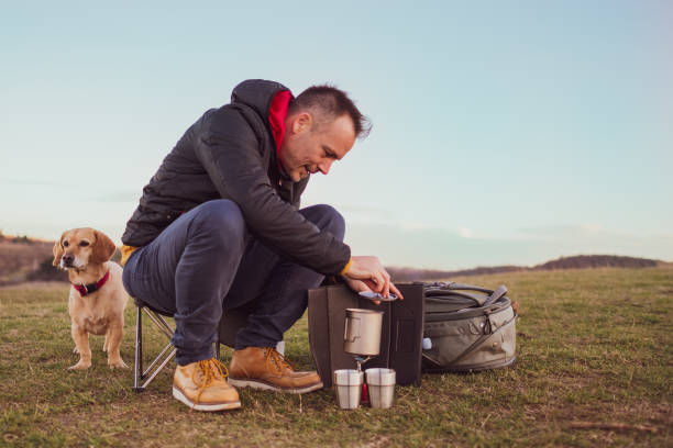 istock Making coffee on the hill with small yellow mix breed dog 1294495753