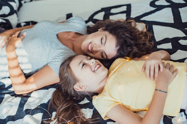istock Mother and daughter on the bed at home 1294496544