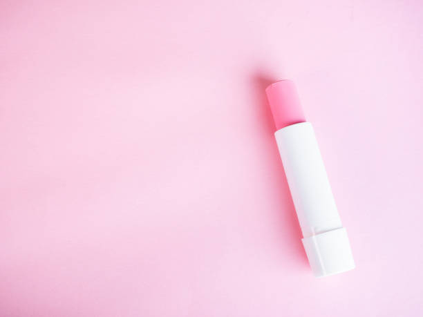 istock Simple pink lip balm on pink background 1294498584