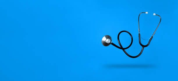 istock Levitating stethoscope on blue background and shadow under it with copy space. Stock photo. 1294499010