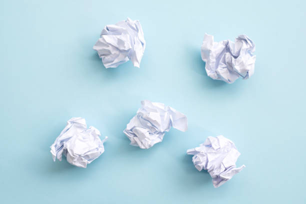 istock Crumpled paper balls on a blue background 1294499024