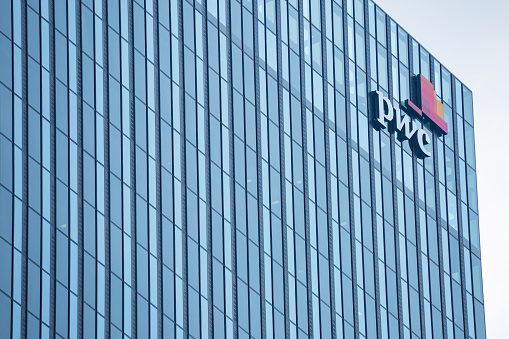 VIENNA, AUSTRIA - JULY 31: Logo of PricewaterhouseCoopers (PwC) on glass facade of building of the DC Tower 1(it the tallest skyscraper in Austria) in Vienna Donau city in Vienna, on July 31, 2019.