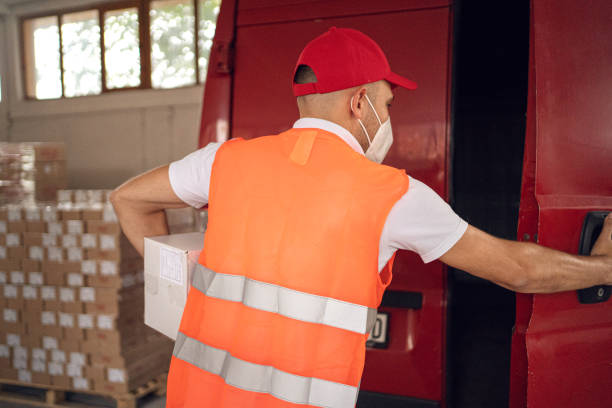 istock Delivery man in front of delivery van with packages 1294505243