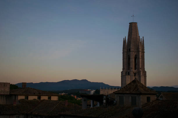 Overview over the catalan city of Gerona with as centerpiece the Esglesia Sant Feliú right between golden hour and blue hour.