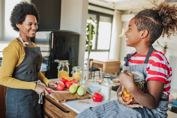 istock Mother and daughter cook together 1294506847
