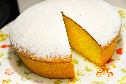 A traditional Italian sponge cake lacking a perfect slice.