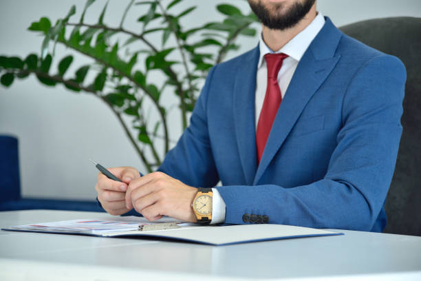 istock Trader man sitting in office and analyzing report. 1294508252