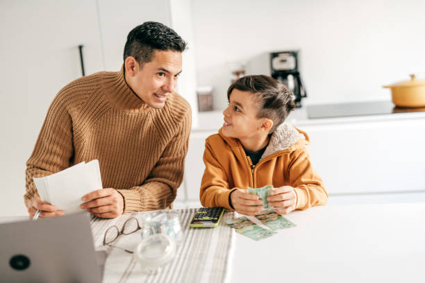 istock Dad and son having nice chat in the home office 1294509738