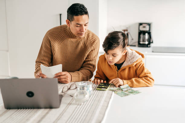 istock Dad and son - homeschooling from home office 1294509741
