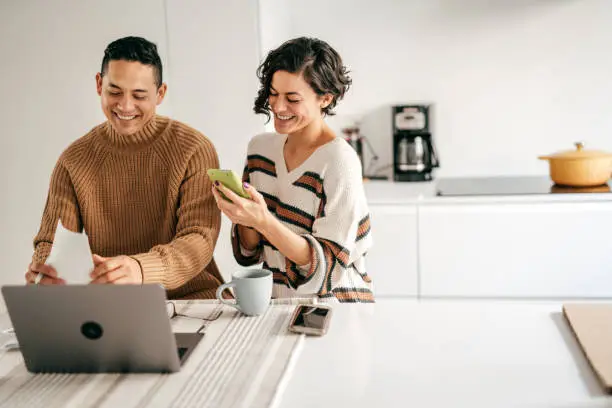 Photo of Couple at home planning family budget