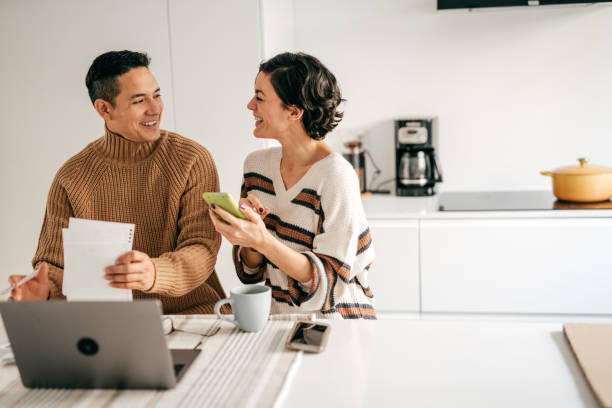 istock Spending less together. Couple is planning next mortgage payments 1294509753