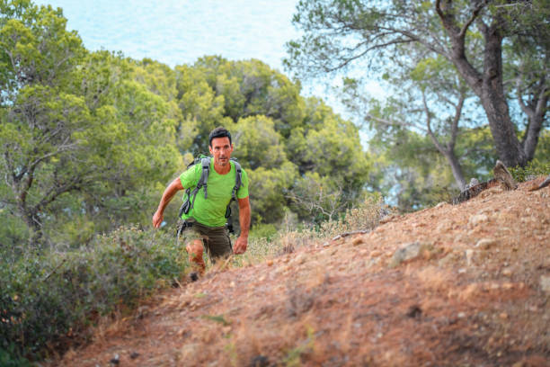 istock Strong Spanish Male Backpacker Climbing Up Trail 1294510616