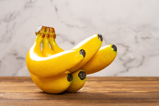 side view artificial bananas on a wood table