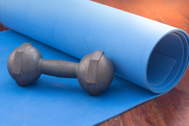 istock Metal dumbbell on yoga mat. 1294510815