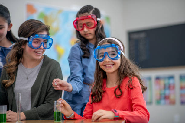 istock Smiling school girl in science class 1294511115