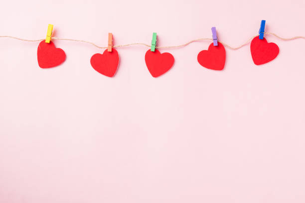 istock red heart shaped valentines decoration hanging with paper clips 1294519102