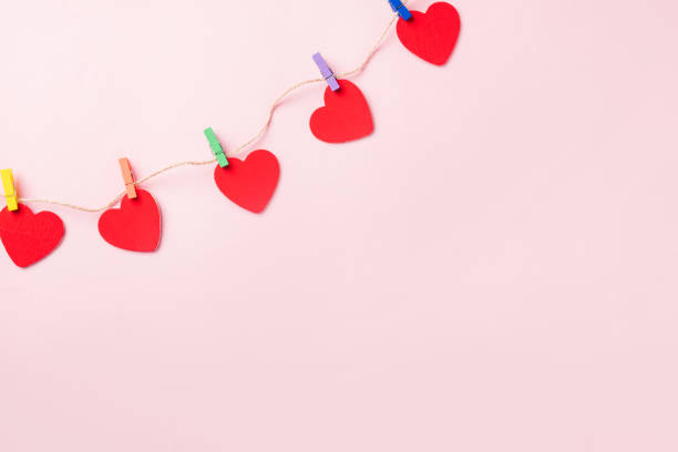 istock red heart shaped valentines decoration hanging with paper clips 1294519103