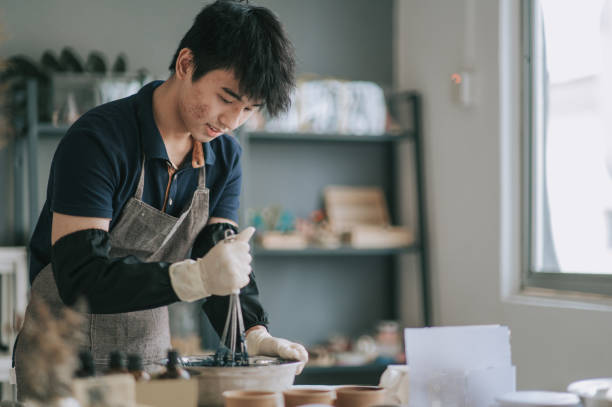 istock Asian chinese teenage boy stirring liquids learning the soap making process 1294519935