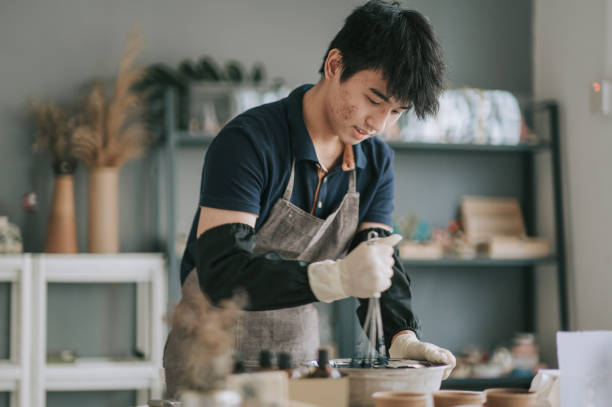 istock Asian chinese teenage boy stirring liquids learning the soap making process 1294520014