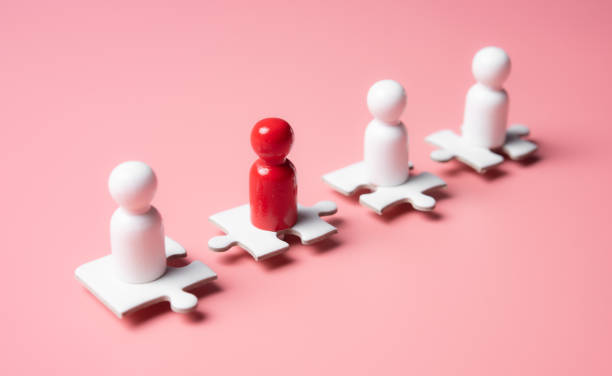 istock People figures on puzzles on pink background,human resources and management concept 1294521829