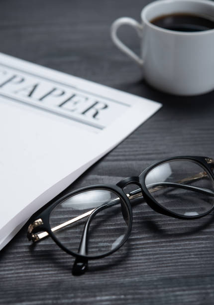 Glasses with daily newspaper on table