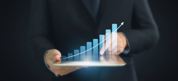 istock Graph growth and increase of chart positive indicators in his business,tablet in hand 1294522405