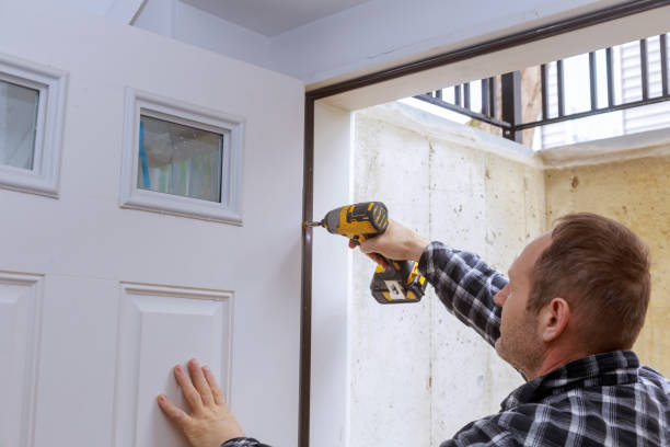 istock Carpenter process of door hinge installation hands screwing hinge with screwdriver 1294525062