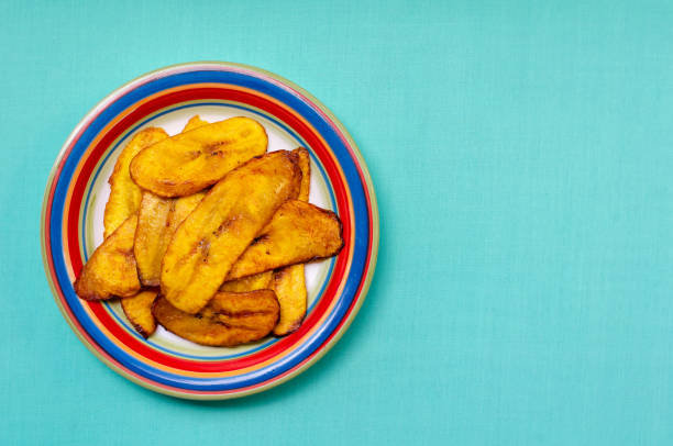 Fried slices of ripe plantains in a plate Slices of fried ripe plantains are usually served as a side dish throughout Latin America. plantain stock pictures, royalty-free photos & images