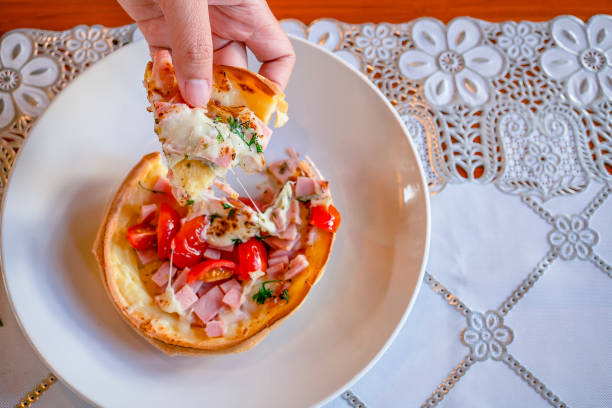 istock Hungarian pancakes langos with ham and cheese close-up on the table 1294536120