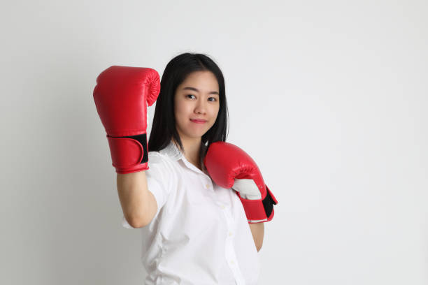 bildung - fist women punching asian ethnicity stock-fotos und bilder