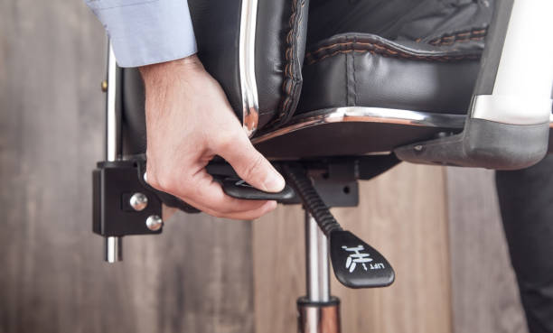 istock Male hand adjusts office chair. 1294540880