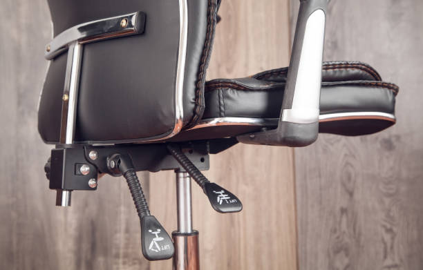 Black leather office chair in wooden background. Black leather office chair in wooden background. adjustable stock pictures, royalty-free photos & images