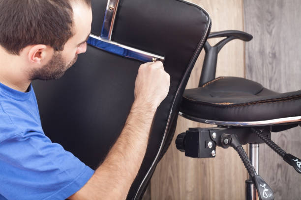 istock Caucasian man repairing office chair. 1294540922