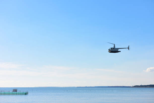 istock Helicopter with floats flying over the sea 1294540968